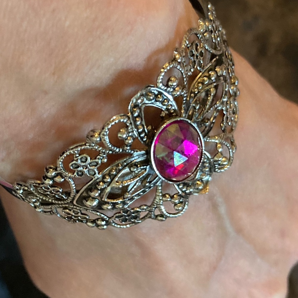 Filigre scrollwork Cuff costume bracelet with pink faux gemstone